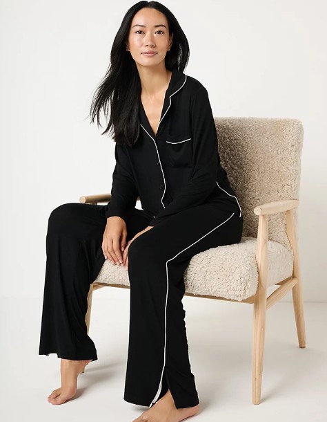 Woman wearing black pajamas.