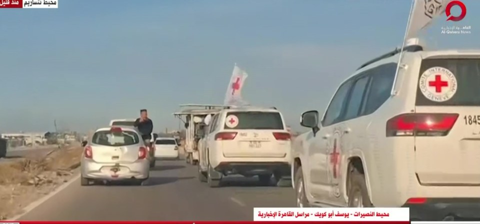 TV news screengrab showing Red Cross vehicles en route to collect hostages from Hamas.