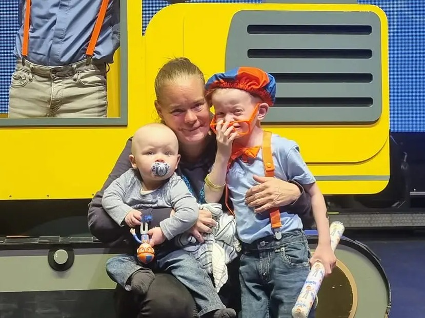 Family posing with Blippi at his world tour.