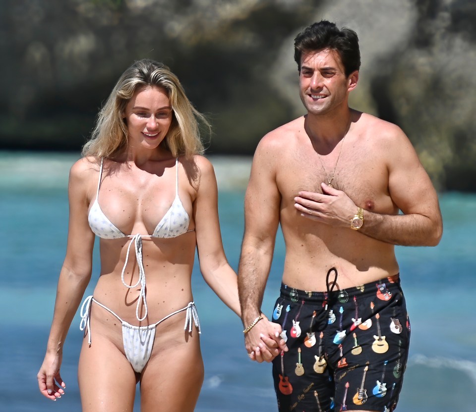 James Argent and his girlfriend holding hands on a beach.