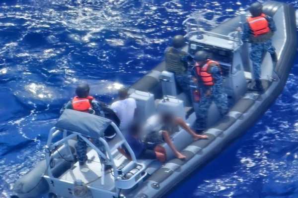 Suspects apprehended on a boat during a joint maritime drug interdiction operation.