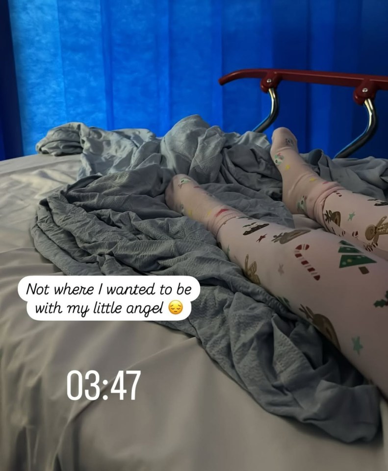 Child's legs in Christmas pajamas in a hospital bed.