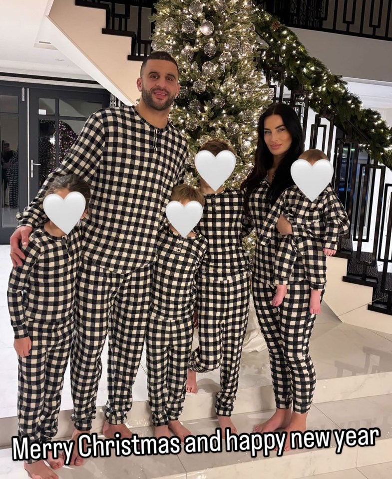 Kyle Walker with his family in matching pajamas by a Christmas tree.