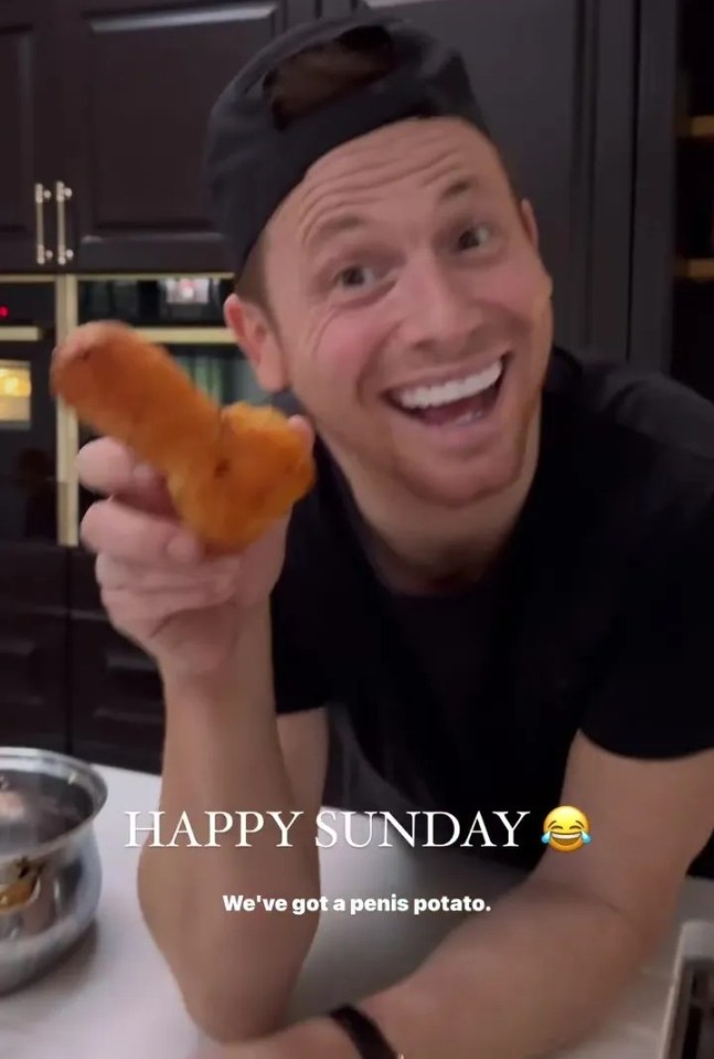 Man holding up a penis-shaped roast potato.