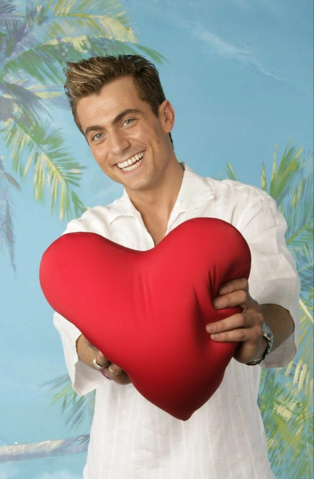 Man holding a heart-shaped pillow.