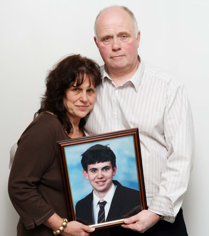 Barry and Margaret Mizen holding a framed photo of their son, Jimmy.