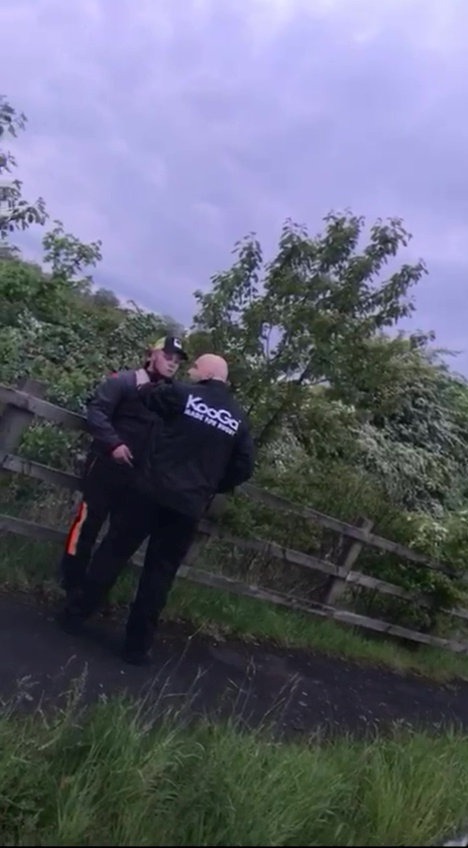 Shane Price being pushed up onto a fence