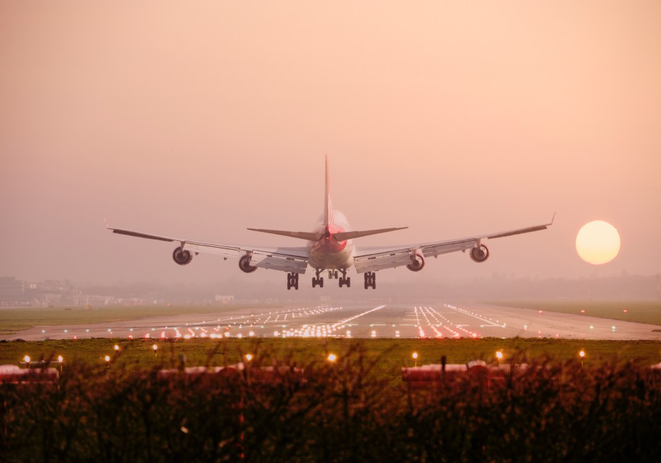 Boeing 747 landing at sunset.