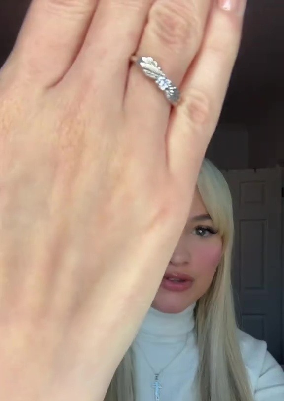 Woman showing off a ring on her hand.