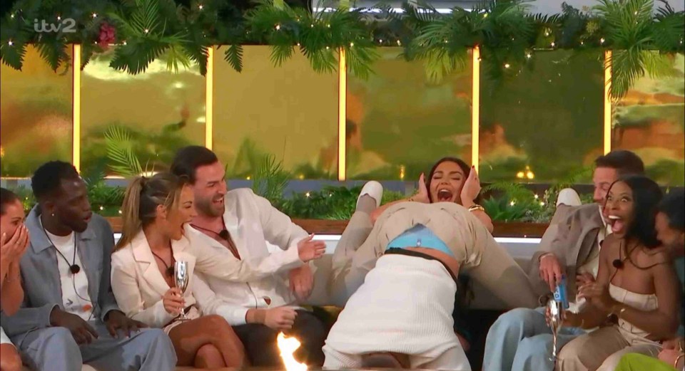 Love Island contestants reacting during a game.