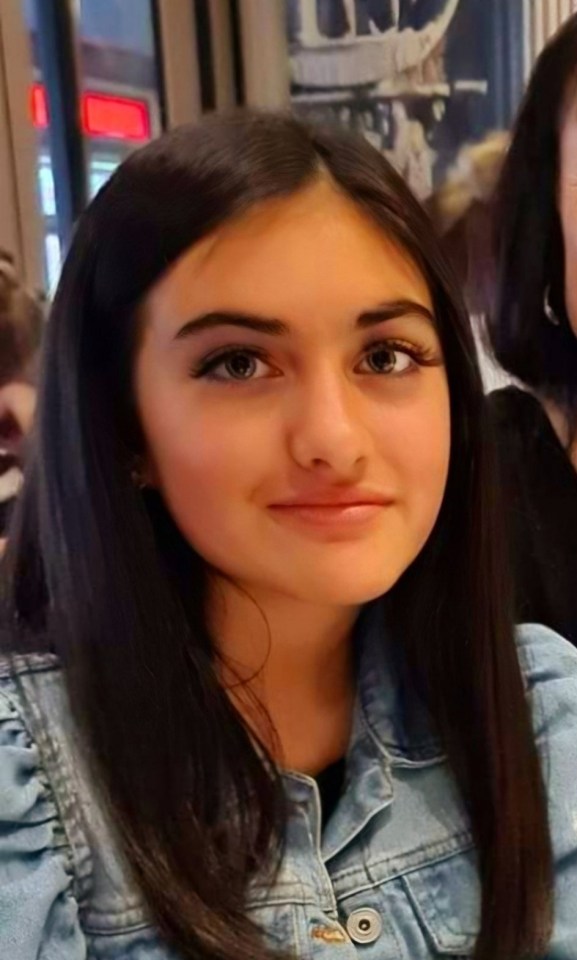 Portrait of a young girl wearing a denim jacket.