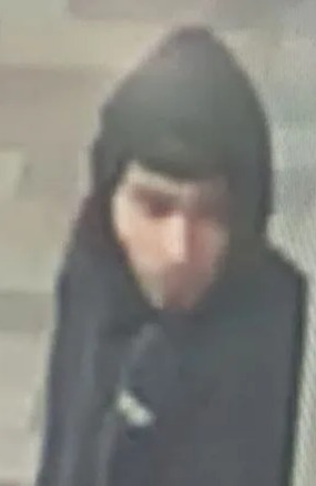 Low-quality CCTV image of a hooded suspect.