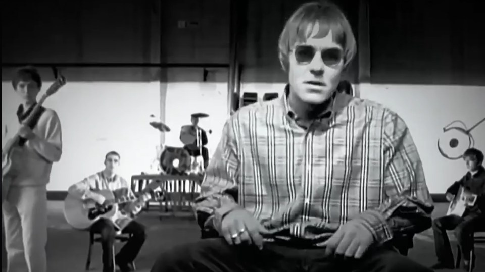 Black and white video still of Matt Moulding's face superimposed onto Liam Gallagher in a Wonderwall music video recreation.