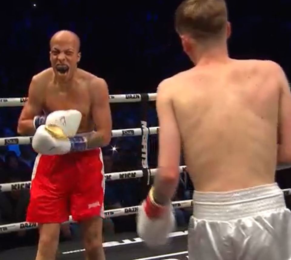 Two boxers facing each other in a boxing ring.