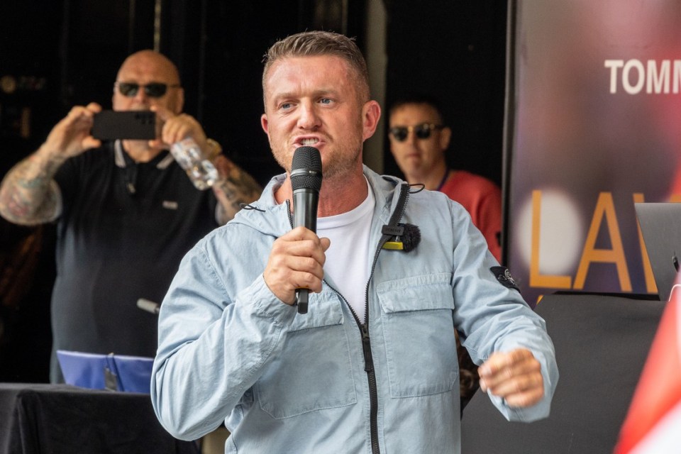 Tommy Robinson leads a large crowd of protesters through Central London