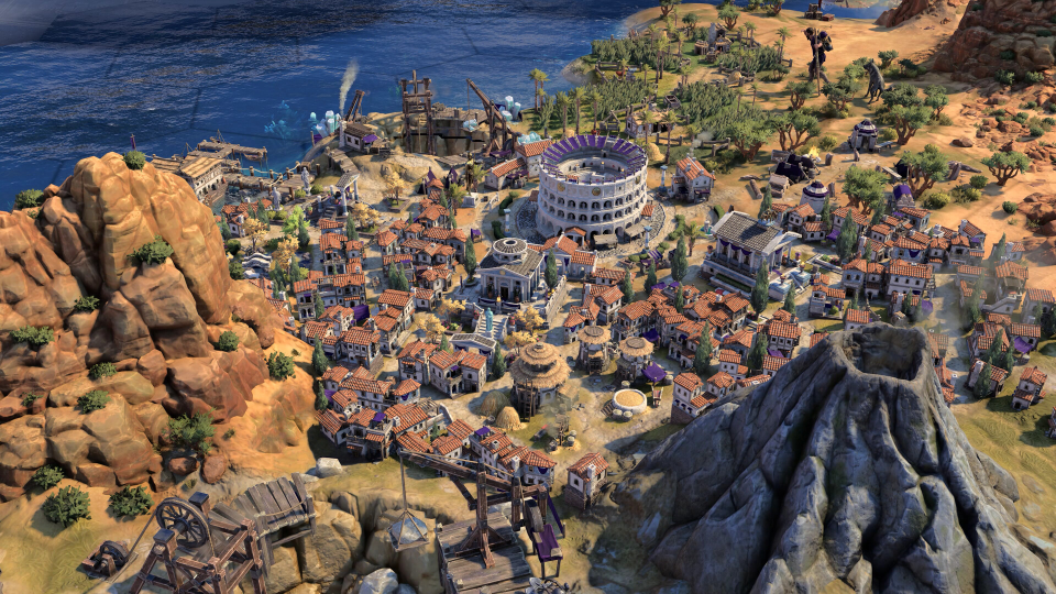 Aerial view of a coastal city in a video game, featuring a coliseum, harbor, and volcano.