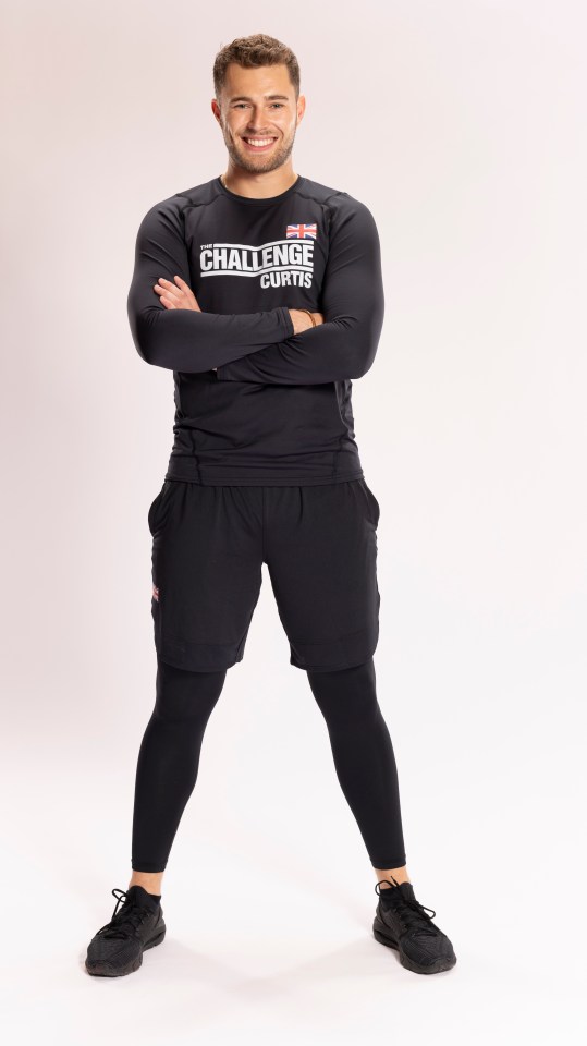 Curtis, a contestant on The Challenge UK, stands with arms crossed.