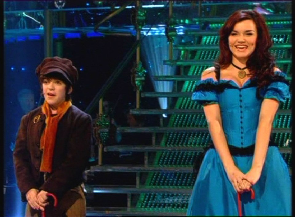 Screenshot from "I'd Do Anything," showing Samantha and Harry performing as Oliver.