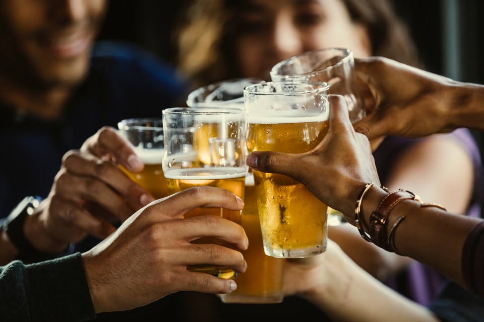 Group of friends toasting with beer.