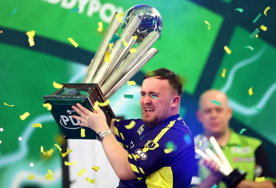 Luke Littler hoists the trophy at Ally Pally