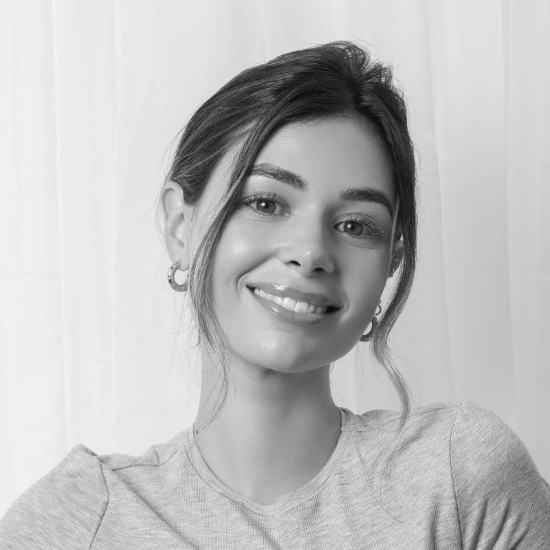 Black and white portrait of a smiling woman.