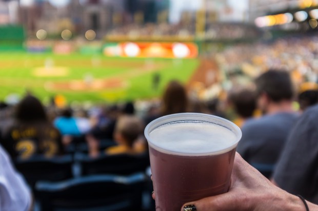 Beer in a plastic cup at a baseball game.