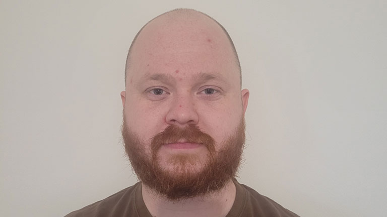 Headshot of a man with a red beard.