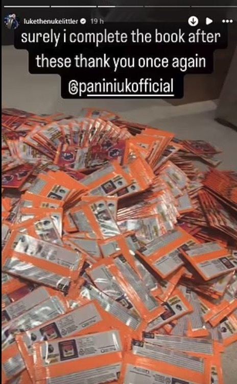 A large pile of orange trading card packs.