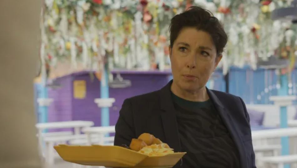 Woman holding a plate of food.