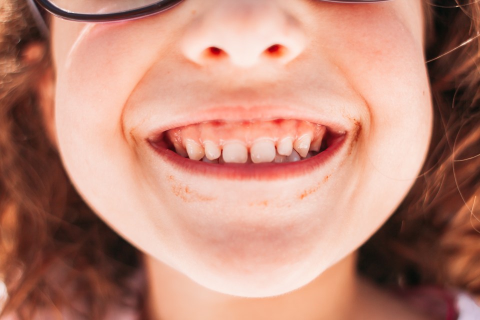 Close-up of a young girl's smiling face.