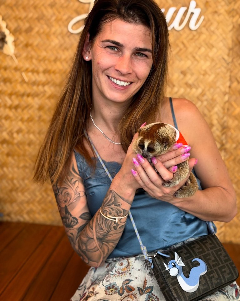 Woman holding a slow loris.