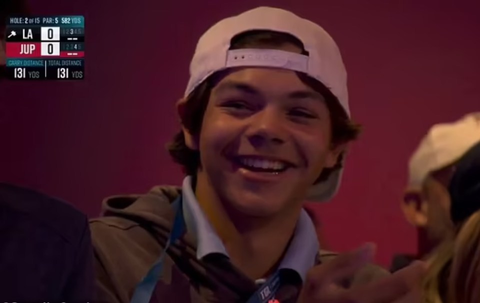 Smiling young man in a white baseball cap.