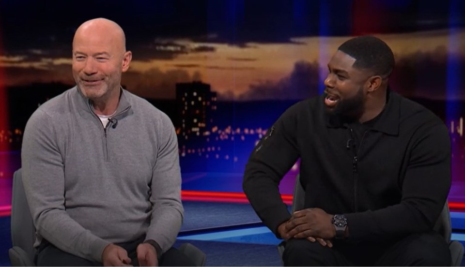 Two men sitting on a talk show set.