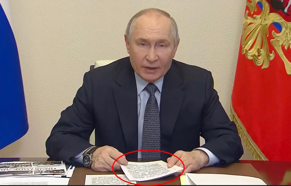 Vladimir Putin holding a document.