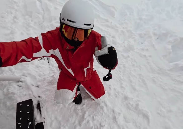 Snowboarder giving thumbs up.