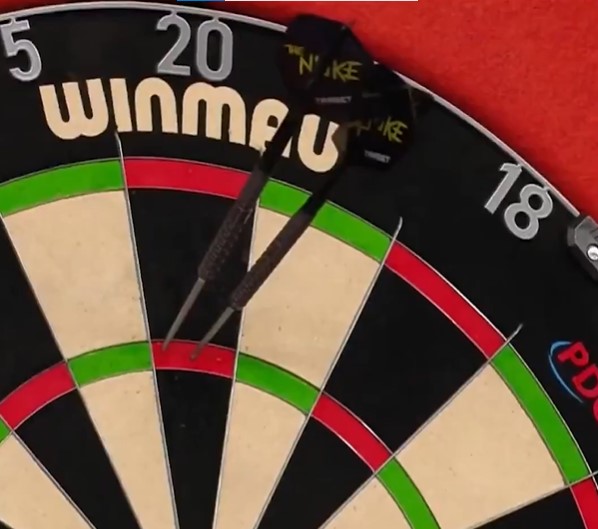 Two darts in a dartboard.