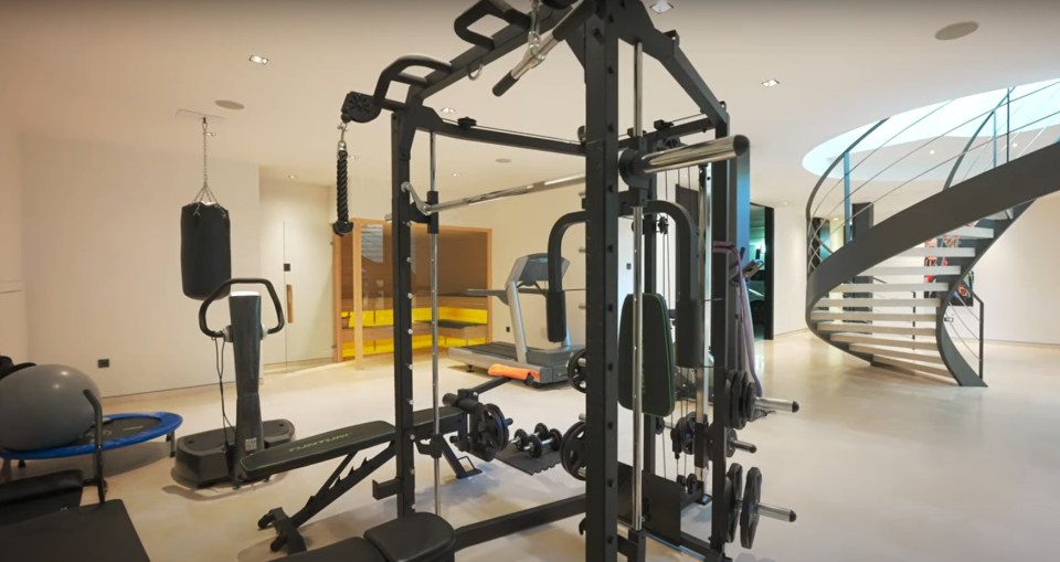 Home gym with weight machine, treadmill, and other exercise equipment.