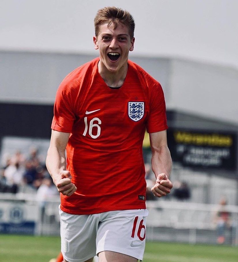 Soccer player in England jersey celebrating.