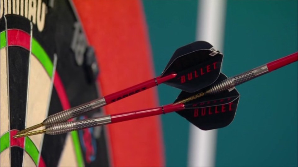 Two darts in a dartboard.