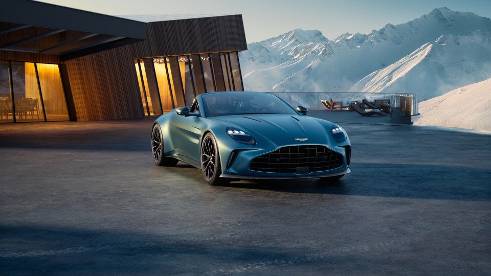 Aston Martin 2025 Vantage Roadster parked outside a modern home in the mountains.