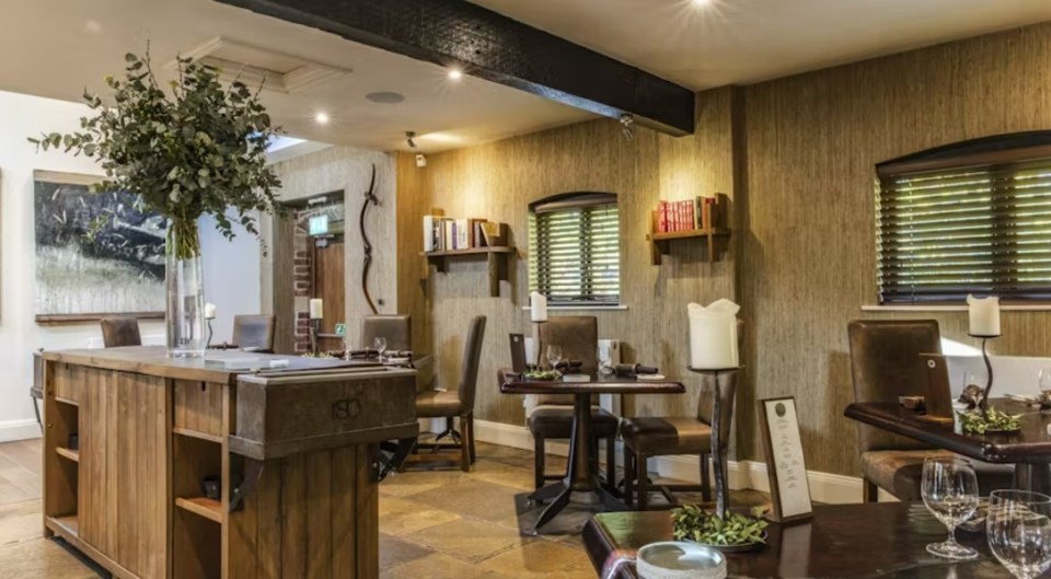 Restaurant interior with wooden tables and chairs.