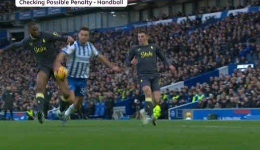 Soccer players contesting a possible handball penalty.