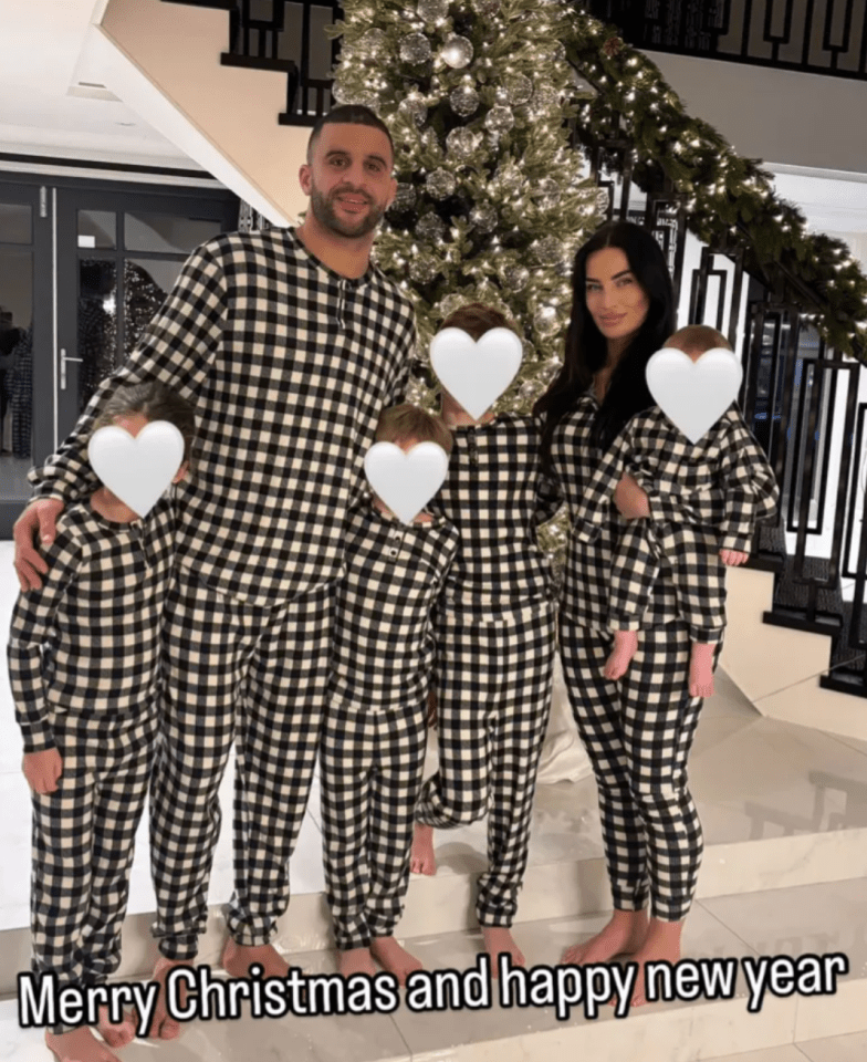 Family in matching pajamas in front of a Christmas tree.