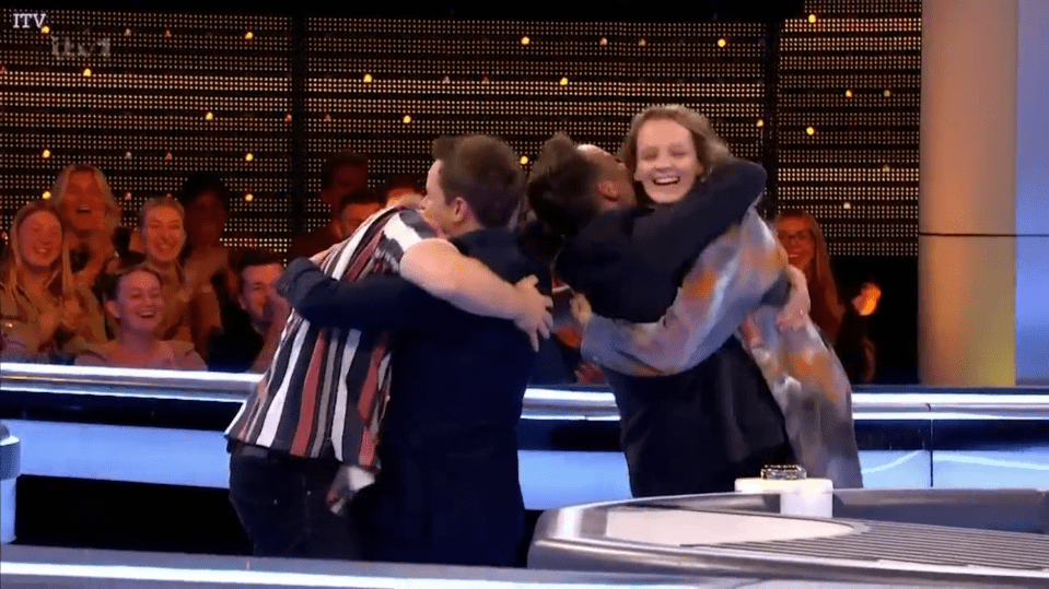 Group hug on game show.