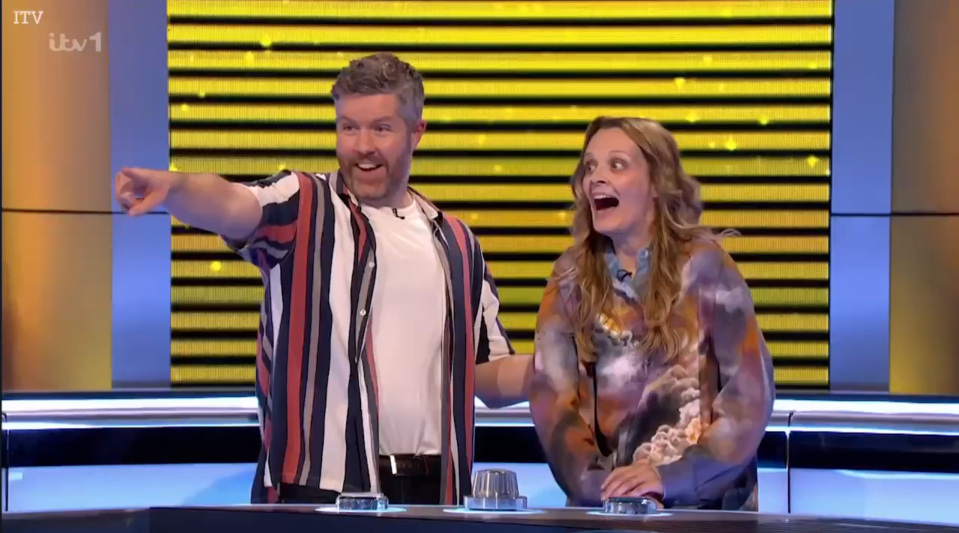 Screenshot of two contestants on a game show, one pointing excitedly.