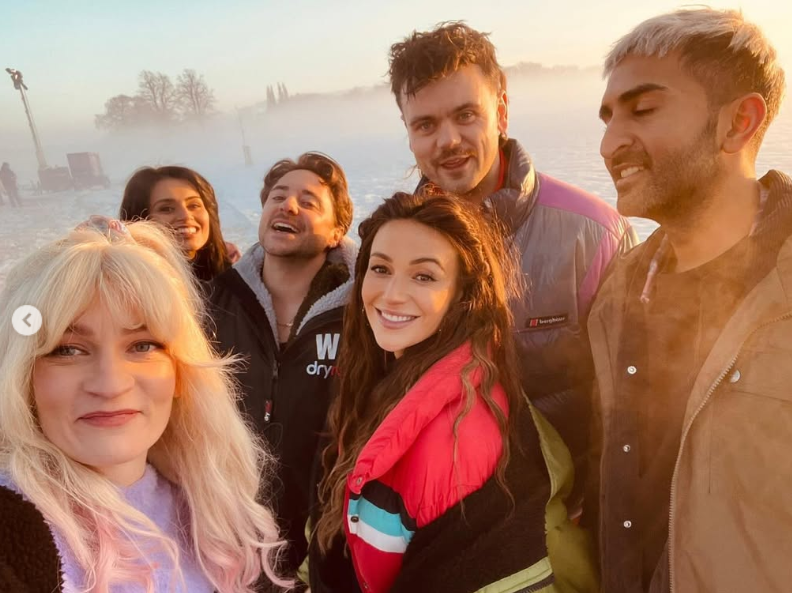 Group photo of six people outdoors in snowy conditions.