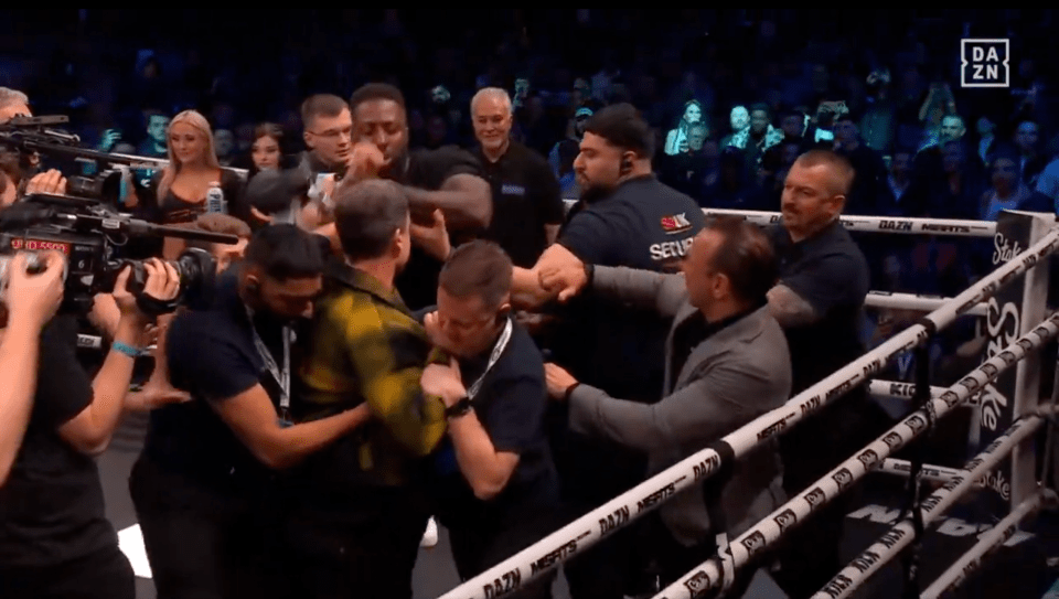 Post-fight altercation in boxing ring.