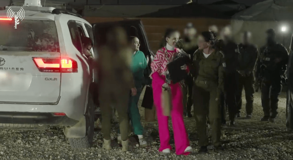 Screenshot of women exiting a vehicle, escorted by soldiers.