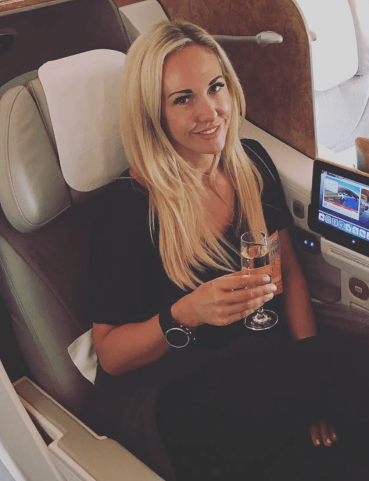 Woman enjoying champagne in first class.