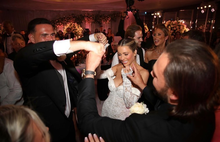 Wedding guests dancing with the bride.